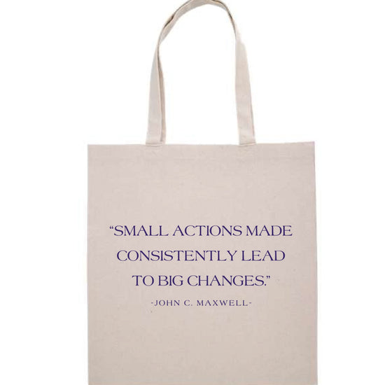 Beige tote bag with motivational quote on a white background